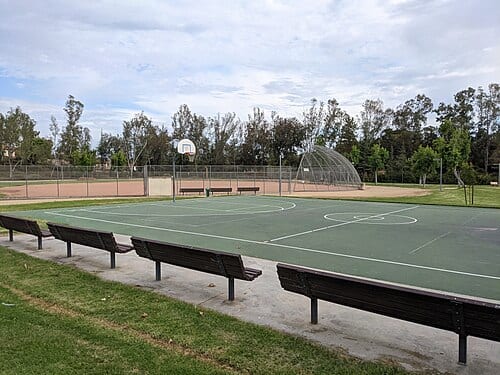 Taken from the loop path of Silverset Park, in Poway, San Diego County, California, USA. There is the basketball court in the foreground and baseball court in the background.