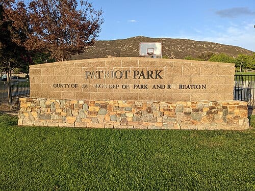 This photo shows the park sign for Patriot Park in 4S Ranch, San Diego. The park is operated by the County of San Diego Park and Recreation department.