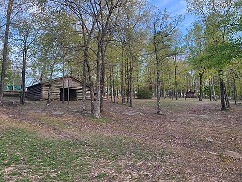 A wooden building surrounded by trees.