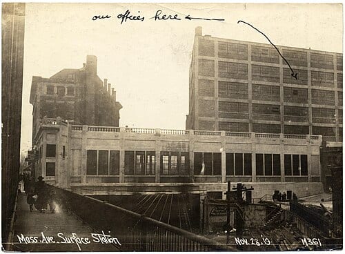 The Massachusetts Avenue surface station over the Boston & Albany Railroad cut in November 1919. "Our offices here" points to the Boston Transit Building, built over the subway station.
