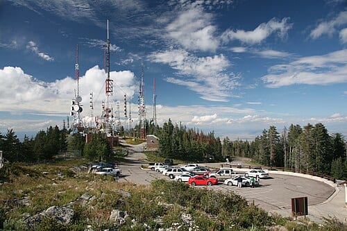 Sandia crest , near Albuquerque, New Mexico , USA, showing antenna farm . Radio transmitting antennas are clustered in a fenced lot at this high geographical point, to give them the maximum transmission range.