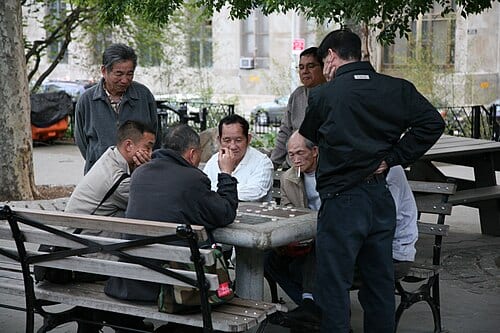 Xiangqi ( Chinese Chess ) players and onlookers in Columbus Park, Manhattan, New York City, USA