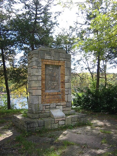 A vandalized historic marker at the w:St. Croix Boom Site just north of Stillwater, Minnesota . The text of the marker once read, "Center of log and lumbering activities in this region for over half a century prior to 1914. Here millions of logs from the upper St. Croix and tributaries were…