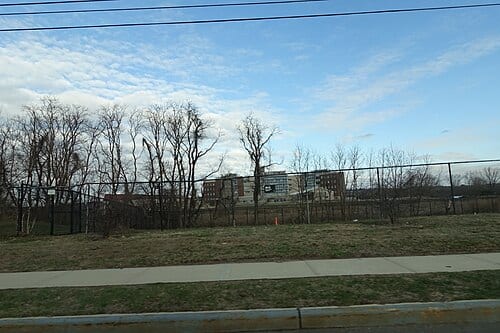 Driving past the western section at the south end of Ocean Breeze Park, on Father Capodanno Boulevard and Seaview Avenue near Midland Beach in South Beach, Staten Island. In the background is the South Beach Psychiatric Center campus.