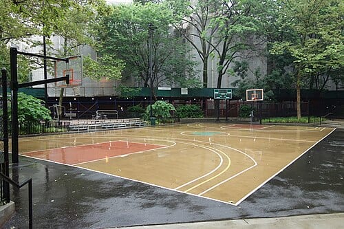 The main basketball court at the north end of Samuel N. Bennerson II Playground, within the Amsterdam Houses at West 64th Street between Amsterdam Avenue and West End Avenue near Lincoln Center in Lincoln Square, Manhattan. The park's two courts were upgraded during the 2018 renovations to the…