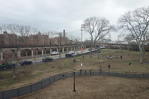 Looking from a Far Rockaway-bound A train traveling down the eastern branch of Hammels Wye on the IND Rockaway Line, at Beach Channel Drive / Rockaway Freeway and Beach 80th Street in Hammels, Rockaway, Queens. Pictured is the Rockaway Freeway Dog Run that occupies the space in between the three…