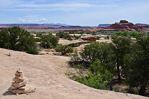 The Cave Spring Trail makes a loop around and over sandstone. The trail is mostly over bare rock with cairns guiding the way. Cave Spring area, Needles District, Canyonlands National Park, Utah.