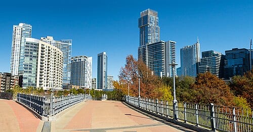 Pedestrian bridge overlooking downtown Austin skyline.